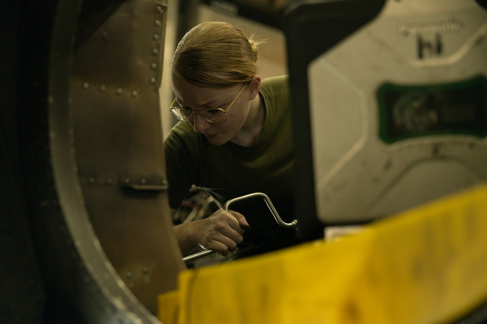 U.S. Marines with VMA-231 conduct maintenance on the AV-8B Harrier II