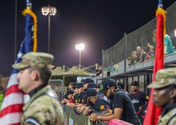 The 380th AEW Honor Guard presents the colors at a Baseball United game