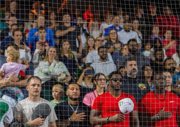 The 380th AEW Honor Guard presents the colors at a Baseball United game