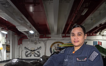 USS John C. Stennis (CVN 74) Sailor Poses For Photo