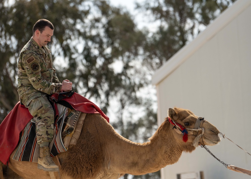 Airmen journey through the sands with a bazaar and camel riding