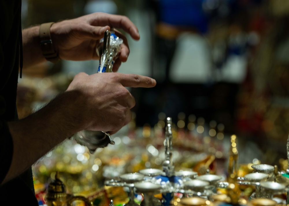 Airmen journey through the sands with a bazaar and camel riding