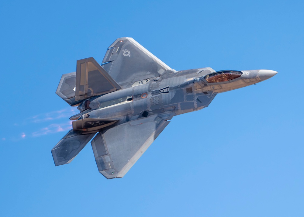 F-22 Raptor performs alongside two Tigers and a Falcon