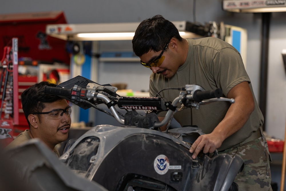 U.S. Soldiers conduct maintenance on CBP vehicles