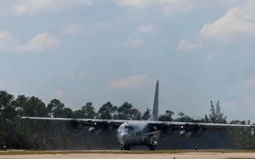 U.S. Marine Corps MV-22B Osprey and U.S. Navy C-130T Hercules aircraft provide assault support to Marines with MWSS-272