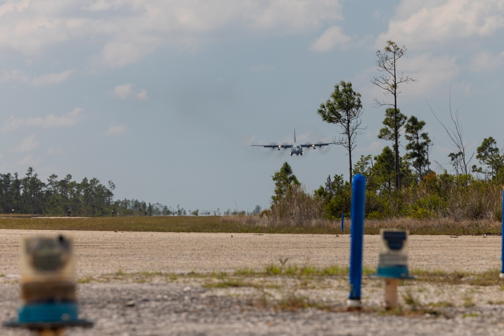 U.S. Marine Corps MV-22B Osprey and U.S. Navy C-130T Hercules aircraft provide assault support to Marines with MWSS-272