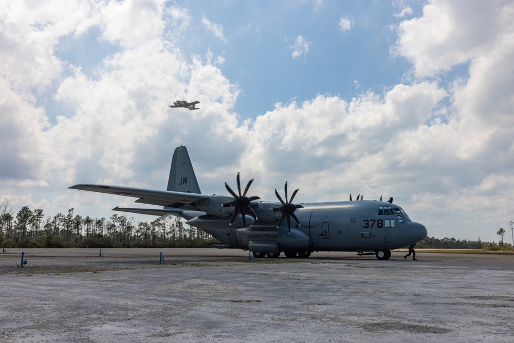 U.S. Marine Corps MV-22B Osprey and U.S. Navy C-130T Hercules aircraft provide assault support to Marines with MWSS-272