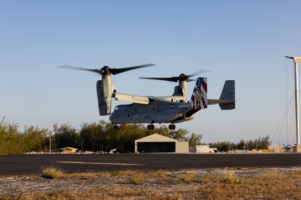 U.S. Marine Corps MV-22B Osprey and U.S. Navy C-130T Hercules aircraft provide assault support to Marines with MWSS-272