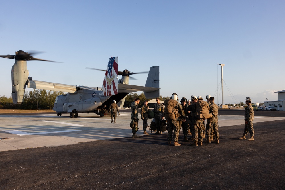 U.S. Marine Corps MV-22B Osprey and U.S. Navy C-130T Hercules aircraft provide assault support to Marines with MWSS-272