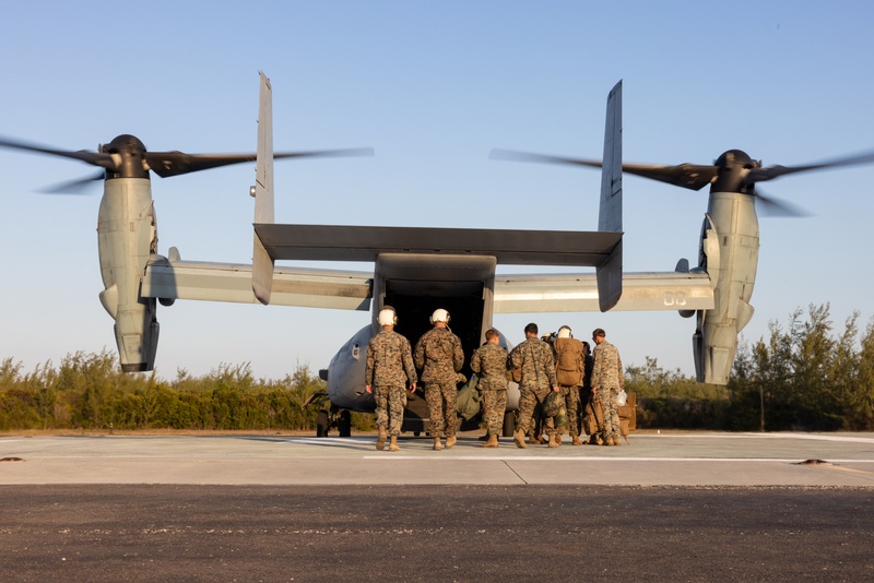 U.S. Marine Corps MV-22B Osprey and U.S. Navy C-130T Hercules aircraft provide assault support to Marines with MWSS-272