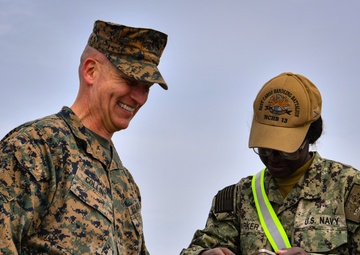 USMC Brigadier General Collins congratulates Navy Sailors on the USNS Dahl