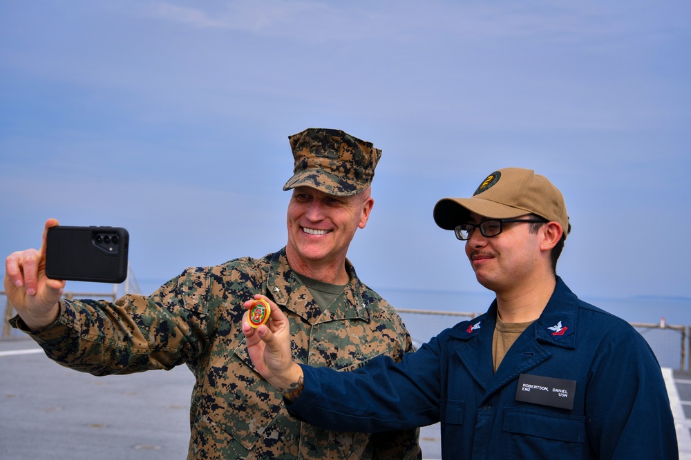 USMC Brigadier General Collins congratulates Navy Sailors on the USNS Dahl