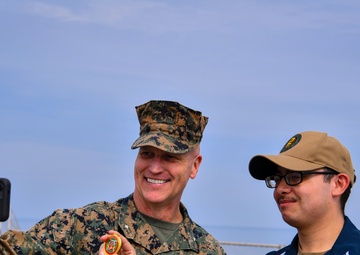 USMC Brigadier General Collins congratulates Navy Sailors on the USNS Dahl