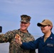 USMC Brigadier General Collins congratulates Navy Sailors on the USNS Dahl