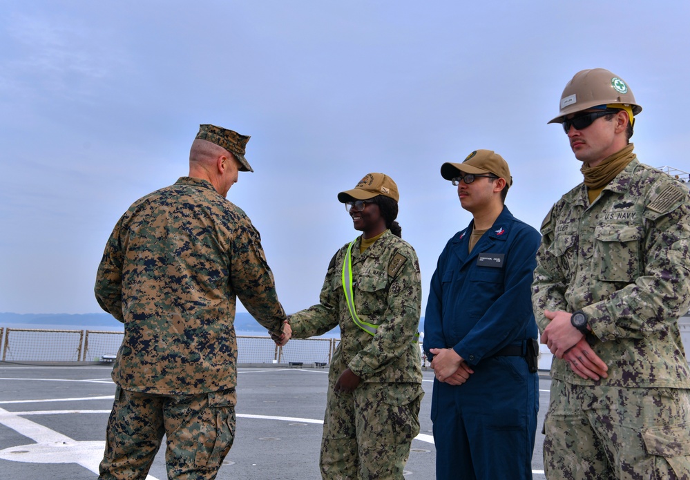 Marine Brigadier General Collins congratulates Navy Sailors on USNS Dahl