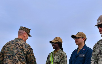 Marine Brigadier General Collins congratulates Navy Sailors on USNS Dahl