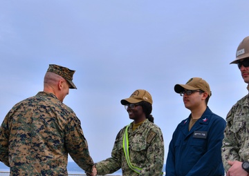 Marine Brigadier General Collins congratulates Navy Sailors on USNS Dahl