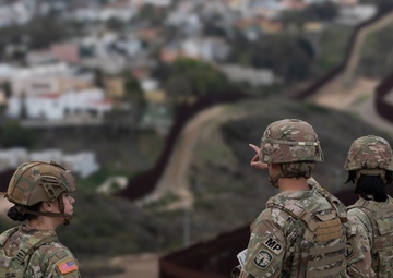 U.S. Soldiers monitor the barrier near Chula Vista