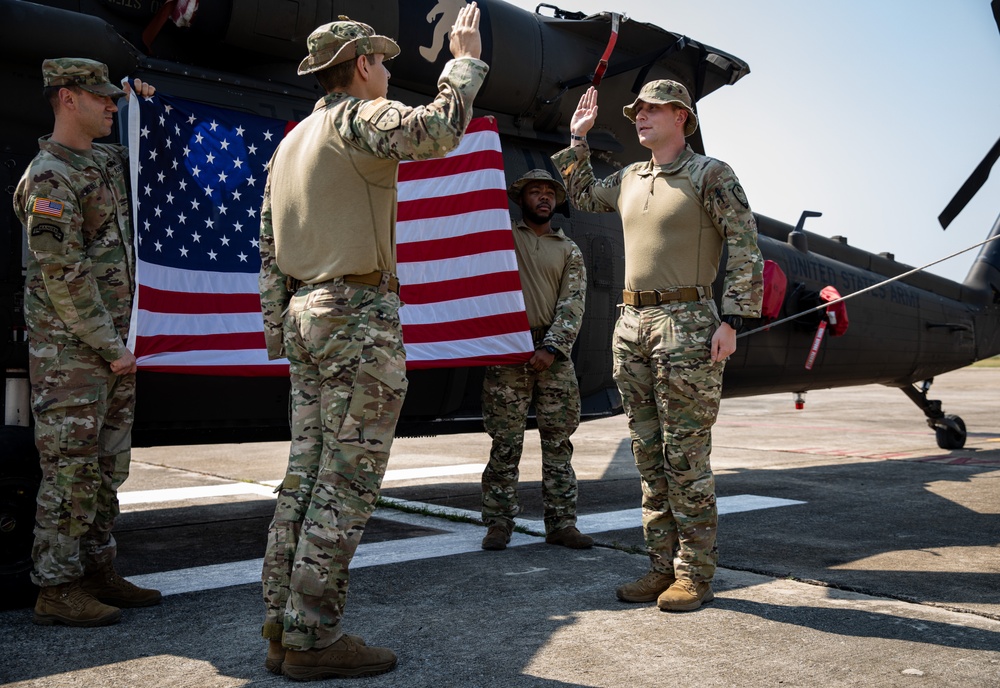 U.S. Air Force Tech. Sgt. Zachary Quicke is given the oath of reenlistment in Thailand, during Joint Exercise Cobra Gold 25