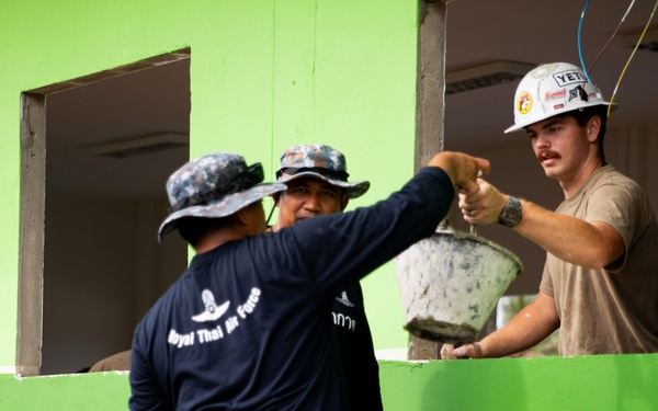 U.S. Air Force Senior Airman Joshua Hartley participates in the building of a school near Lop Buri, Thailand