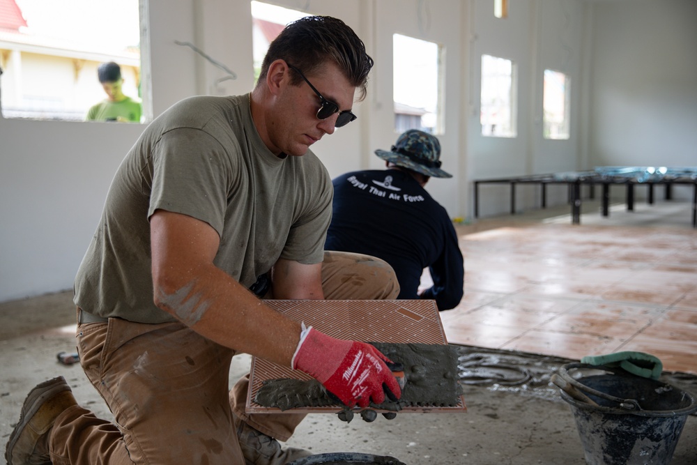 U.S. Air Force Senior Airman Gabriel Earnest participates in the building of a school near Lop Buri, Thailand