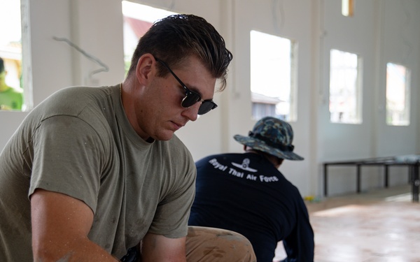 U.S. Air Force Senior Airman Gabriel Earnest participates in the building of a school near Lop Buri, Thailand