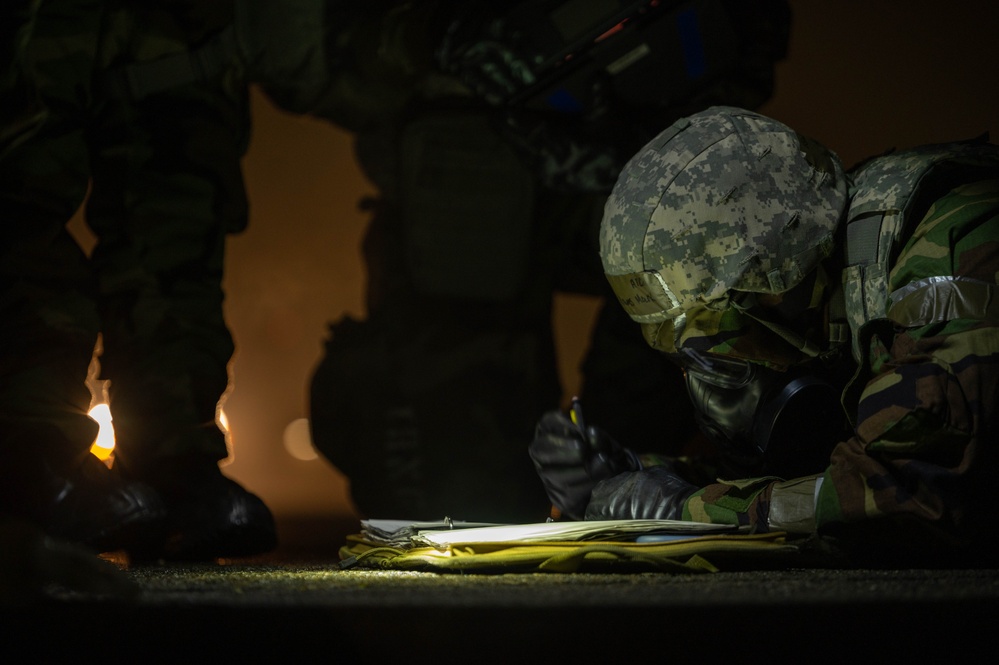 Yokota Airmen perform decontamination of aircraft, aircrew during BM 25-2
