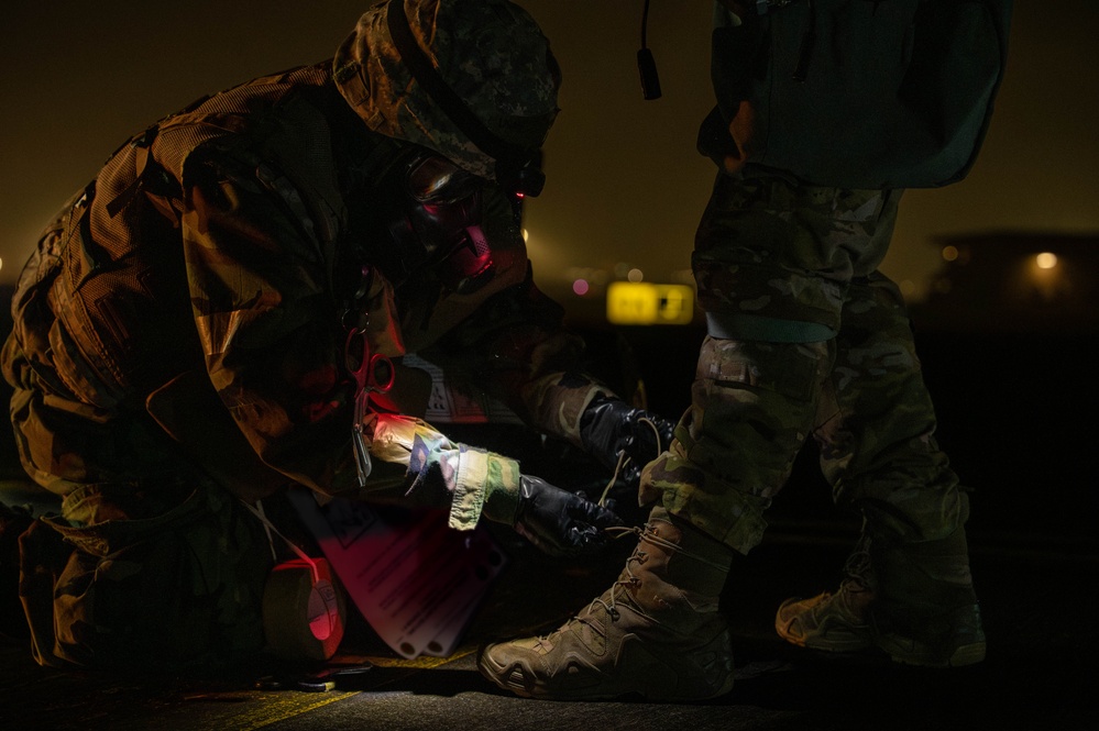Yokota Airmen perform decontamination of aircraft, aircrew during BM 25-2