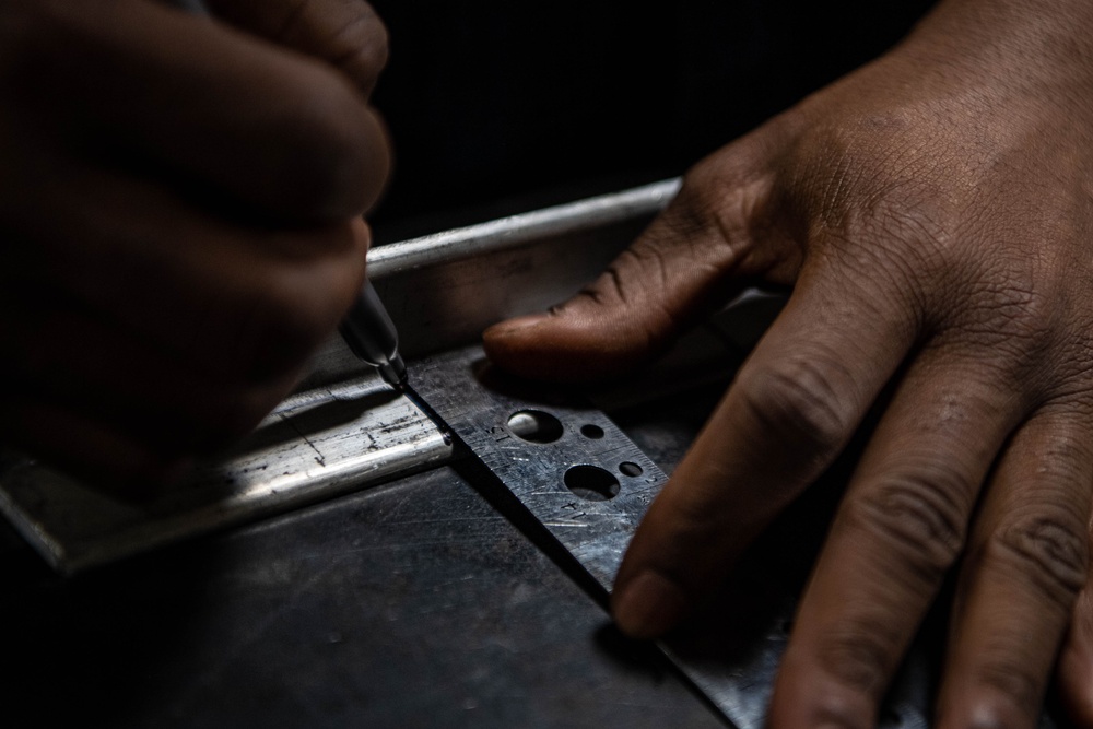 USS Ronald Reagan (CVN 76) Sailor cuts Angle Irons