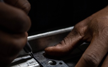 USS Ronald Reagan (CVN 76) Sailor cuts Angle Irons