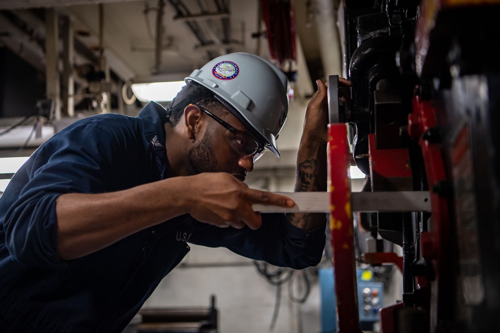 USS Ronald Reagan (CVN 76) Sailor cuts Angle Irons