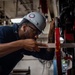 USS Ronald Reagan (CVN 76) Sailor cuts Angle Irons