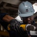 USS Ronald Reagan (CVN 76) Sailor cuts Angle Irons