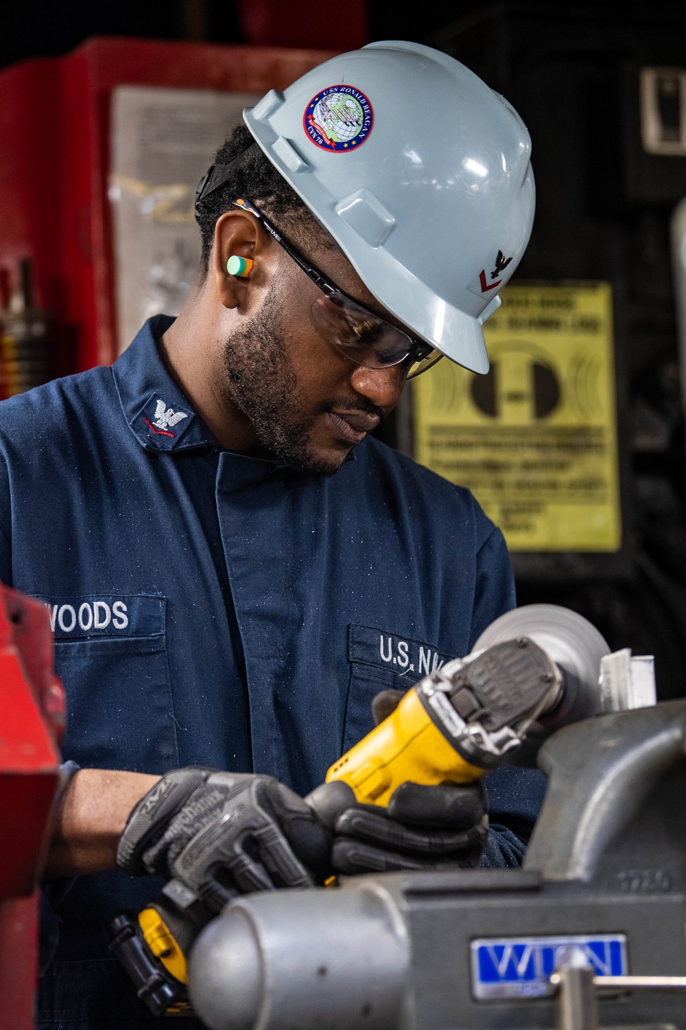 USS Ronald Reagan (CVN 76) Sailor cuts Angle Irons