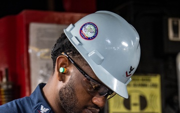 USS Ronald Reagan (CVN 76) Sailor cuts Angle Irons