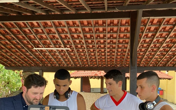 Dr. Brad Fawver (left) and Maj. Rodrigo Bandeira Silva (right), co-principal investigators on the study, demonstrate to pilot participants how to use the cognitive training and testing platform.