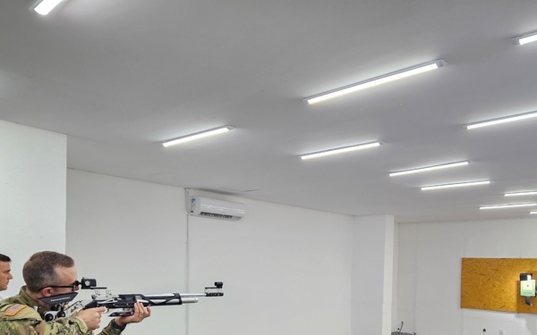 Maj. Jeff Osgood (right) receives instruction by Sgt. Geison Loan Bordin (left) and participates in a demonstration of the SCATT Shooting System