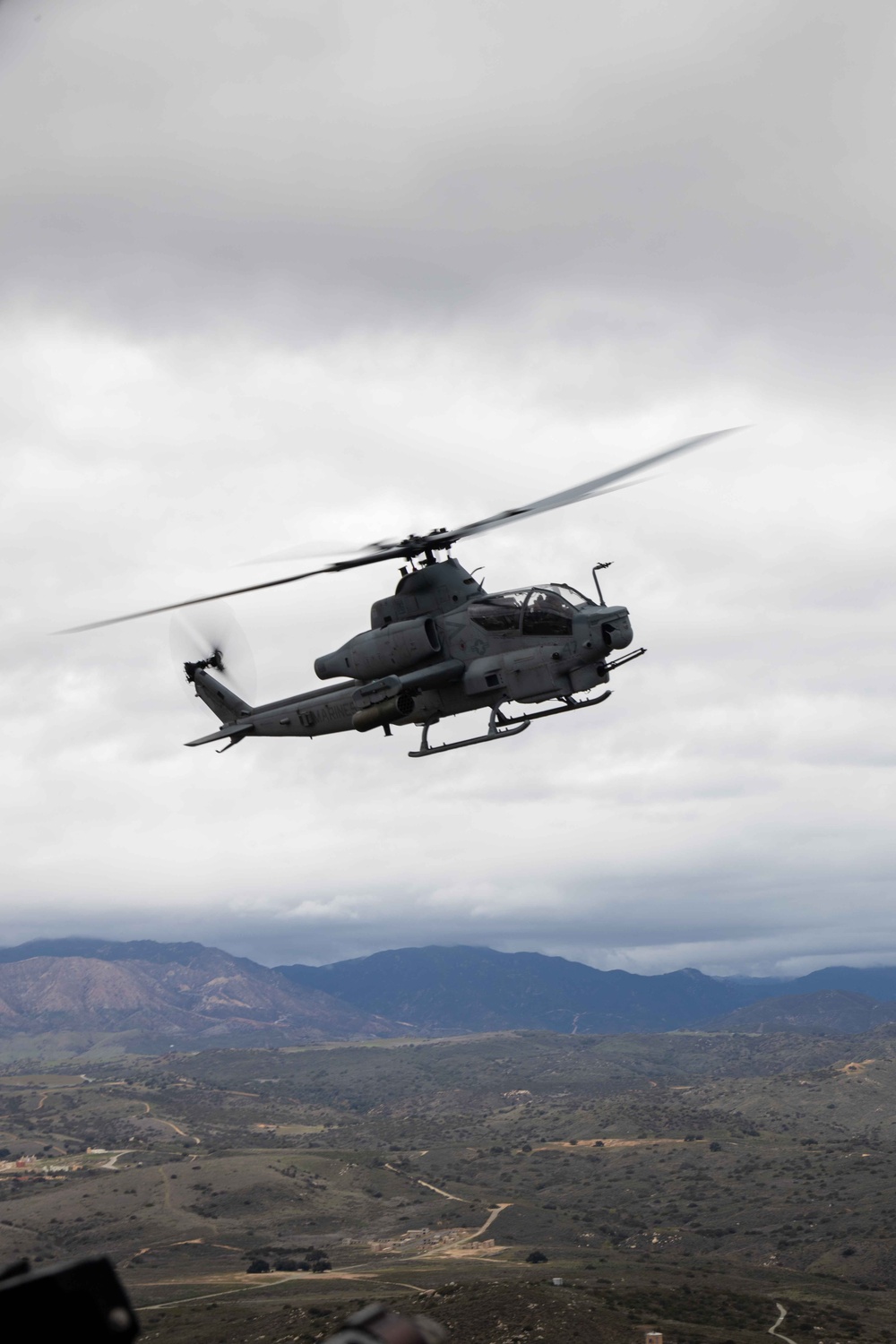 U.S. Marines with HMLA-367 fly over Miramar National Cemetery to honor veteran