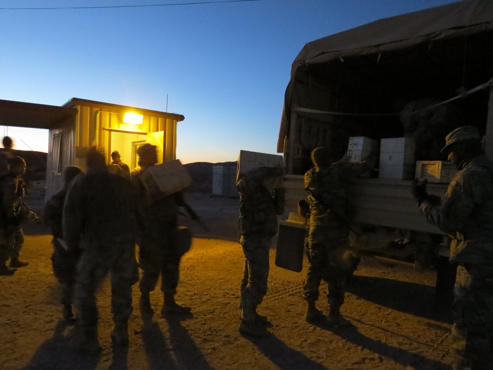 HHC 650th RSG loads ammo into LMTV