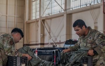 647 LRS contingency response team prepares parachutes for cargo drops