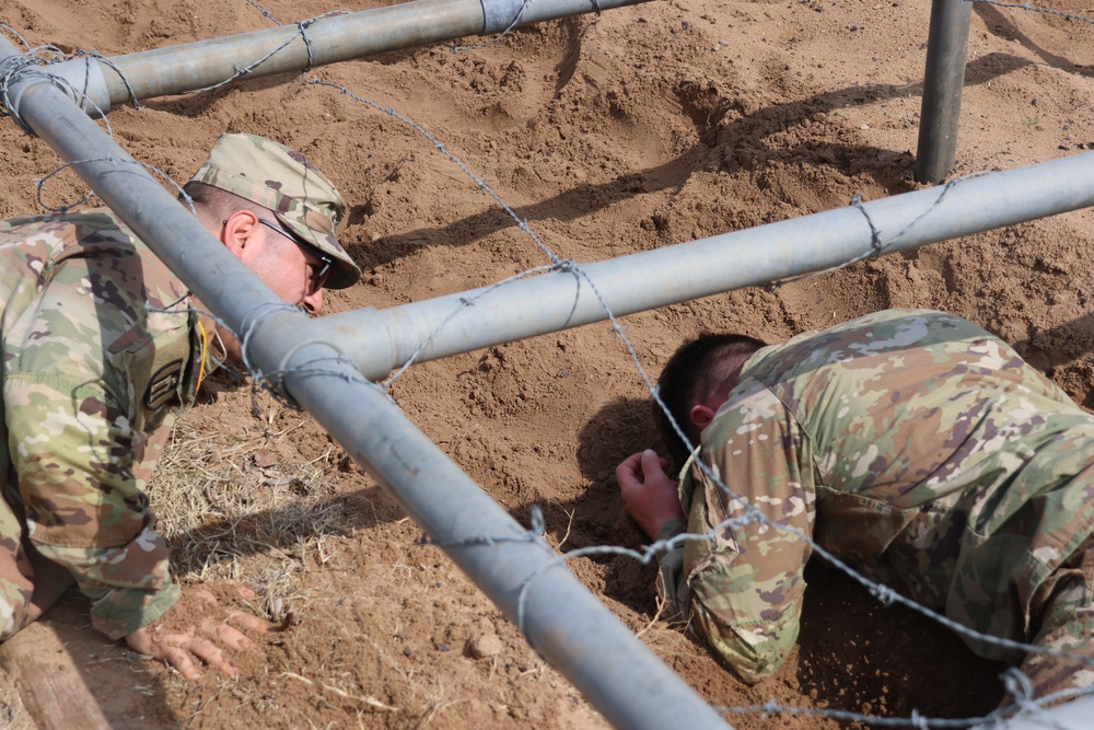 Soldier conquers low crawl obstacle