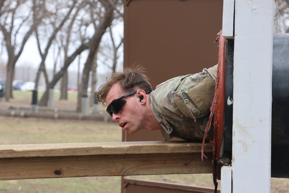 451st ESC competitor negotiates obstacle