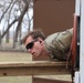 451st ESC competitor negotiates obstacle