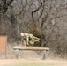 Soldier leaps over obstacle