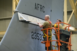 914th ARW craftsmen install new fin flash on KC-135 Stratotanker