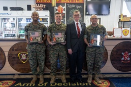 Retired Marine presents gifts to 1/10