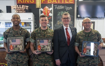 Retired Marine presents gifts to 1/10