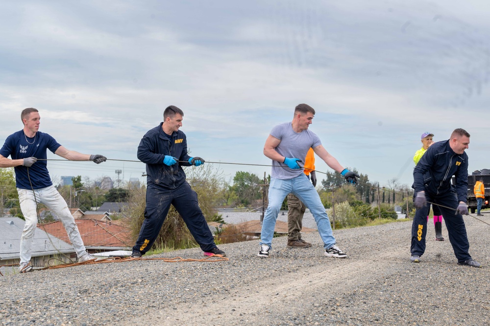 Sailors volunteer with the River City Waterway Alliance