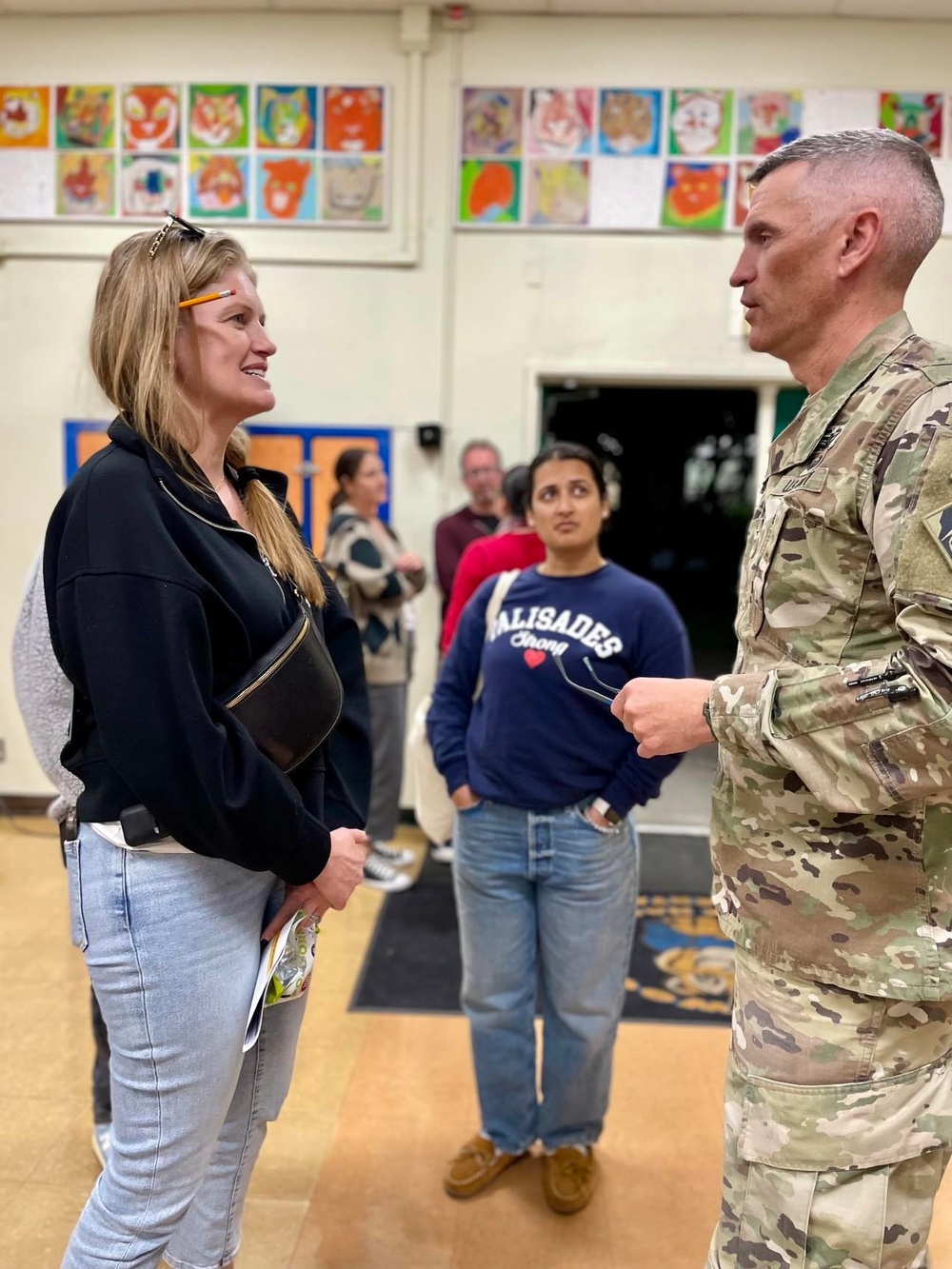 Col. Brian D. Sawser visits with Palisades Elementary School families during a townhall meeting