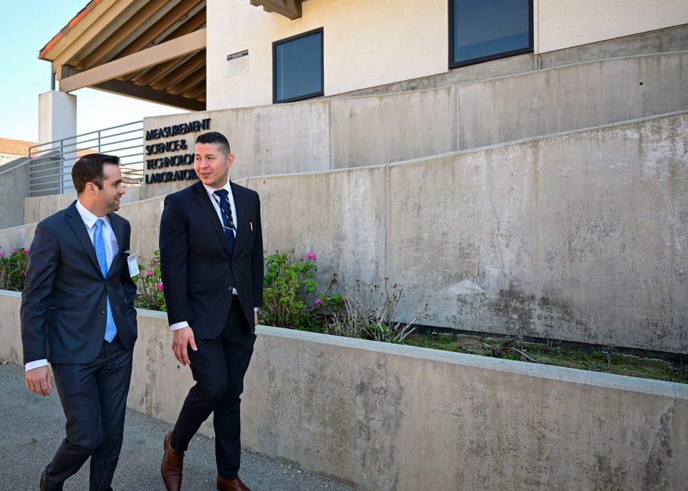 Technical Director Elvis Acosta speaks to Casey Deaver, district director for the office of Assemblyman Bill Essayli, during an official visit to Naval Surface Warfare Center, Corona Division.